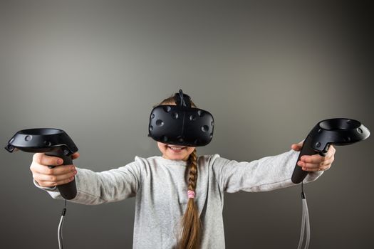 Child with virtual reality headset and joystick