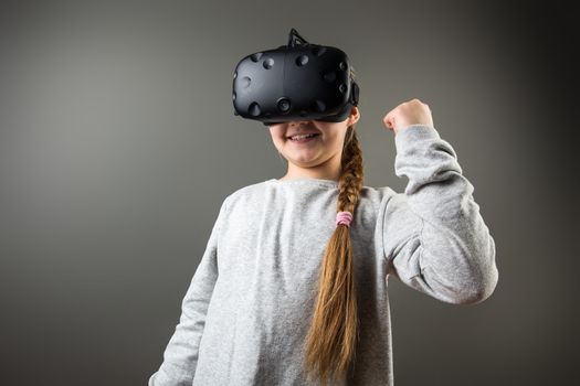 Happy little girl using a virtual reality headset