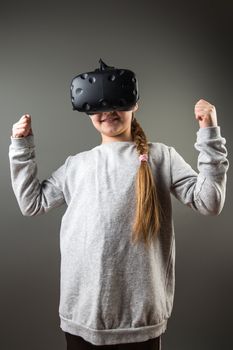 Happy little girl using a virtual reality headset