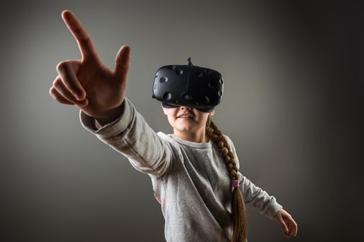 Happy little girl using a virtual reality headset