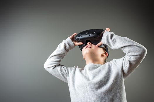 Happy little girl using a virtual reality headset