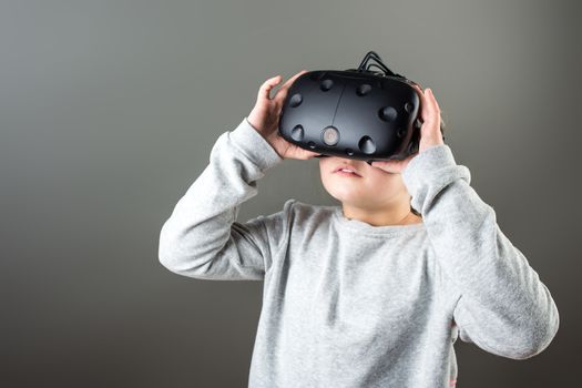 surprised little girl using a virtual reality headset