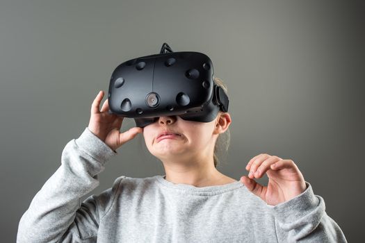 Happy little girl using a virtual reality headset