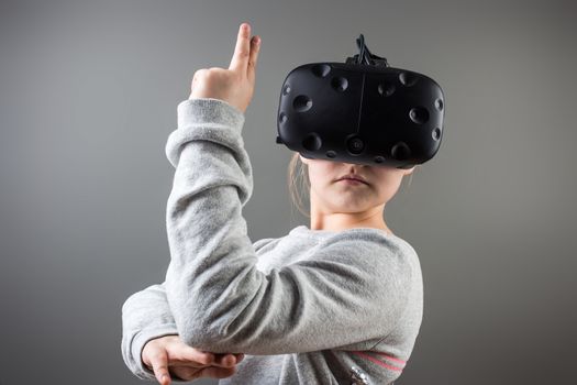 Happy little girl using a virtual reality headset