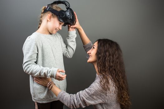 Mother and child playing together with virtual reality headsets