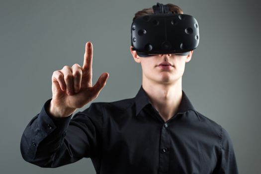 Closeup of male hand.young man wearing virtual reality goggles. Smartphone using with VR headset