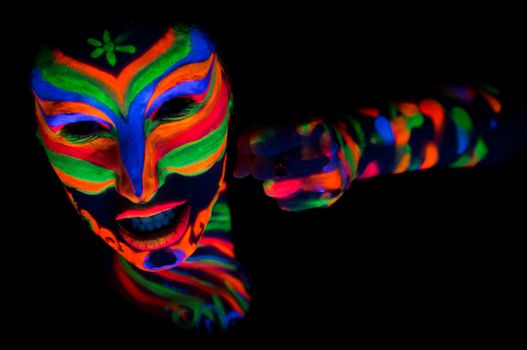 Woman with make up art of glowing UV fluorescent powder.