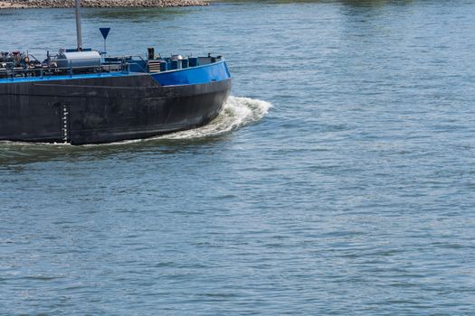 Bug of a large merchant ship, container ship on a large river.