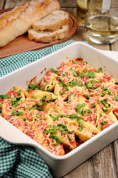 pasta conchiglioni shells stuffed meat mince with spinach and tomato sauce , Parmesan cheese. 
