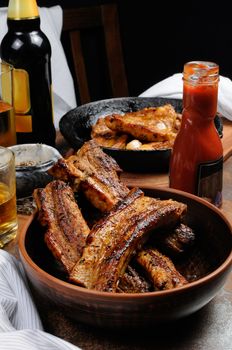 Fried spicy, sharp pork ribs with beer and ketchup. Vertical shot.