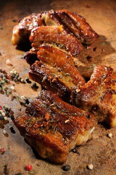 Marinated fried pork ribs with spices, garlic and cumin. Vertical shot. View from above.