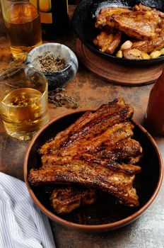 Fried spicy, sharp pork ribs with beer and ketchup. Vertical shot.