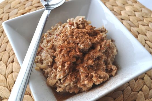 Healthy breakfast - oat flakes with grated apple and mashed banana sprinkled with cinnamon