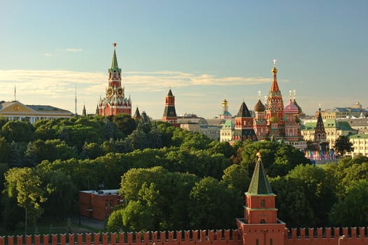 Evening view on Moscow Red Square Kremlin towers red square wall stars and Clock Kuranti Saint Basil Cathedral church. Panorama from bell tower. Moscow holidays vacation famous sightseeing tours