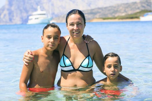 Family swimming on the beach