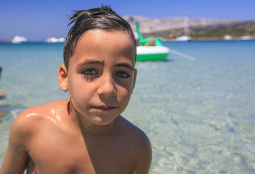 green eyes boy on the beach