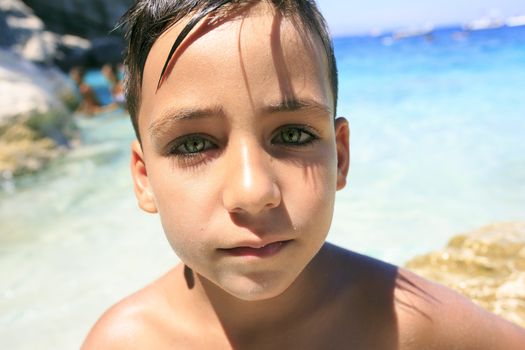 green eyes boy on the beach