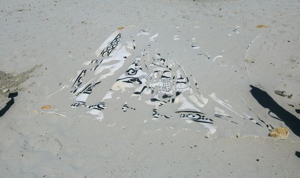 towel buried on the sand of the beach