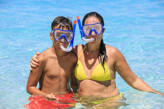 Mother and son snorkeling on the beach