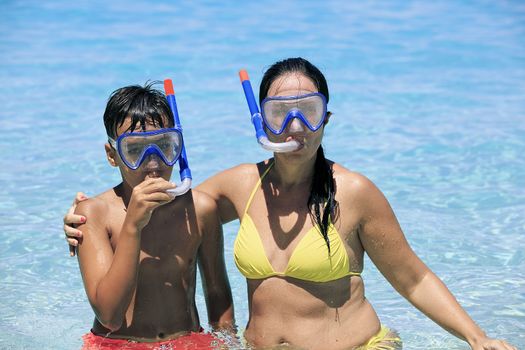 Mother and son snorkeling on the beach