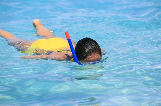 woman snorkeling on the beach