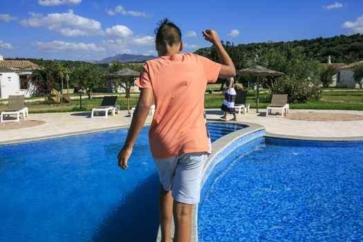 Boy  walking over the swimming pool