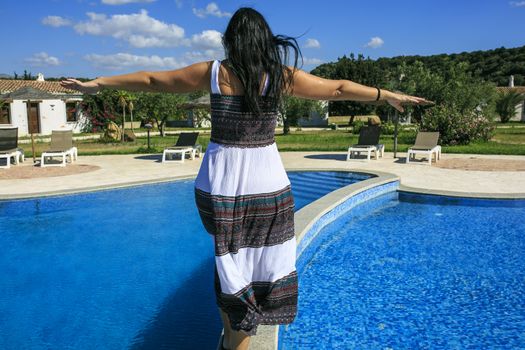 Girl walking over the swimming pool