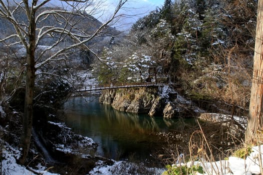 A conduit crosses a river in Shirakawago