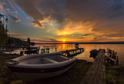 Sunning sunset at sea shore with boat on the beach