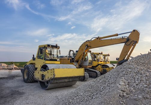 drum roller and excavators in construction site 