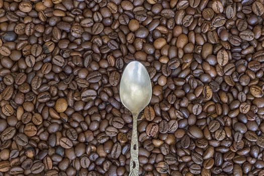 silver spoon and coffee beans as the background