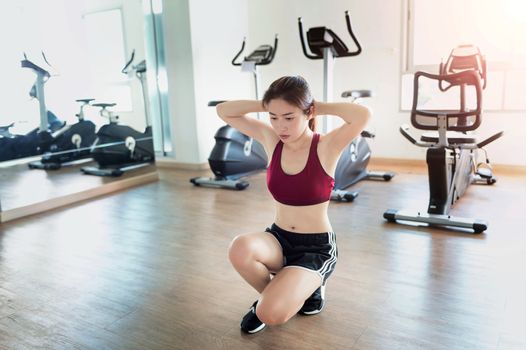 Young fitness woman executed exercise in gym.