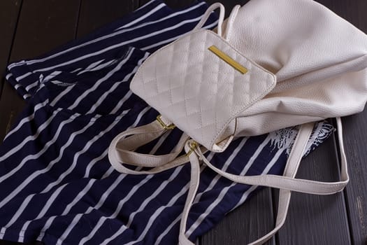 White Leather Women's Backpack on a Striped T-shirt