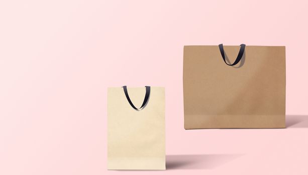 Two paper bags for shopping on a pink background