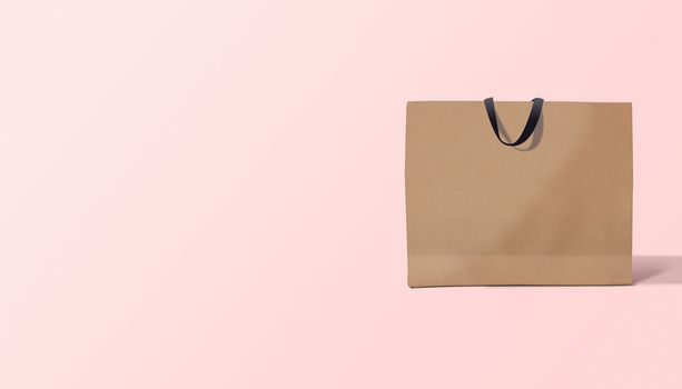 paper bag for shopping on a pink background