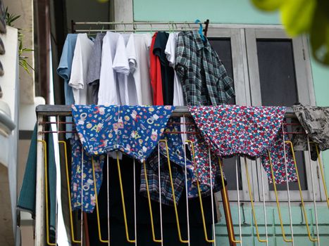 COLOR PHOTO OF CLOTHES DRYING ON THE BALCONY
