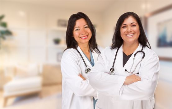 Female Hispanic Doctors or Nurses Standing in an Office.