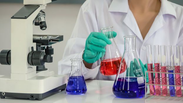 Portrait of Asian scientific researcher working in laboratory