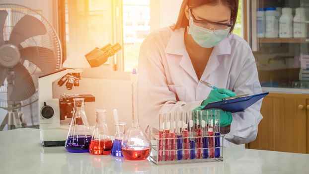 Portrait of Asian scientific researcher working in laboratory