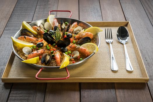 Paella with seafood vegetables and saffron served in the traditional pan