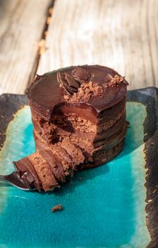 Creamy chocolate mousse layered cake with rich fudge icing