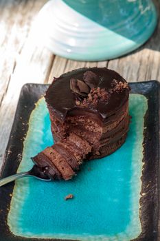 Creamy chocolate mousse layered cake with rich fudge icing
