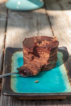 Creamy chocolate mousse layered cake with rich fudge icing