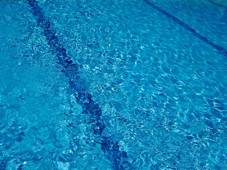 Blue ripples in the  water of a  swimming pool great summer fun vacation image