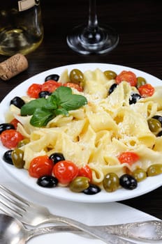 Pasta with olive, garlic, basil and tomatoes and seasoned with Parmesan cheese. 