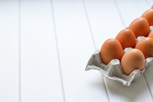 Eggs in the paper tray package on white background.