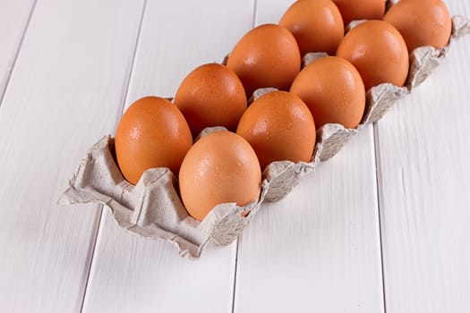 Eggs in the paper tray package on white background.