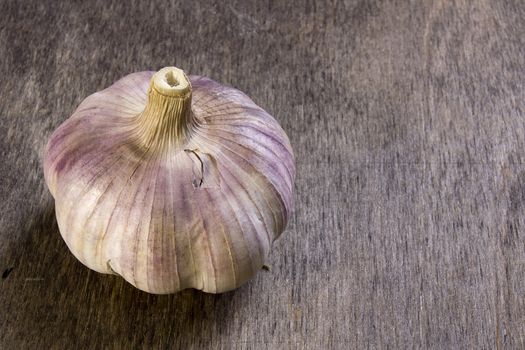 Ripe fresh garlic on a brown wooden table