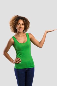 Beautiful African American woman showing something on her hand