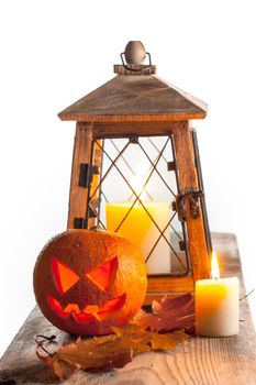 Halloween pumpkin and lantern with candle on white background